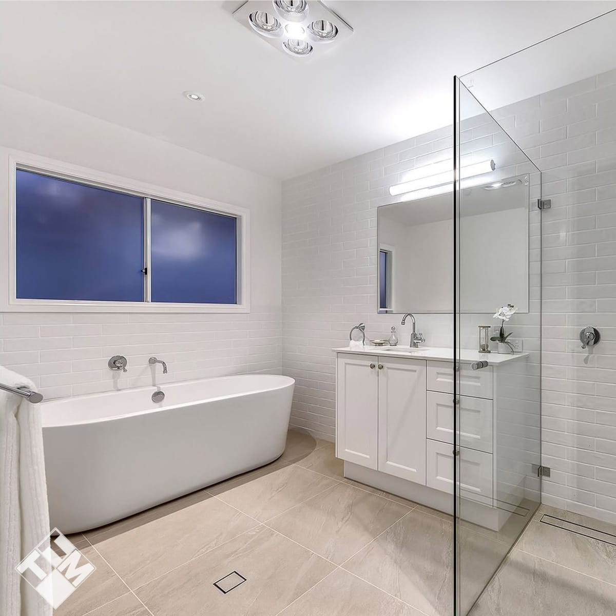 Freestanding bath, frameless shower and large-format wall tile — bathroom and ensuite tiling in Brisbane by Torrisi Tiling