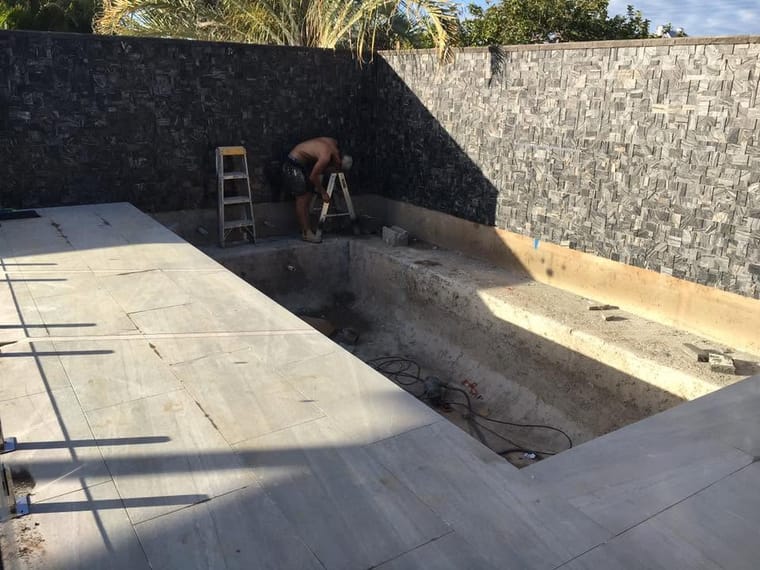 Pool surround under way — pavers laid to fall — tiling by Torrisi Tiling, Brisbane