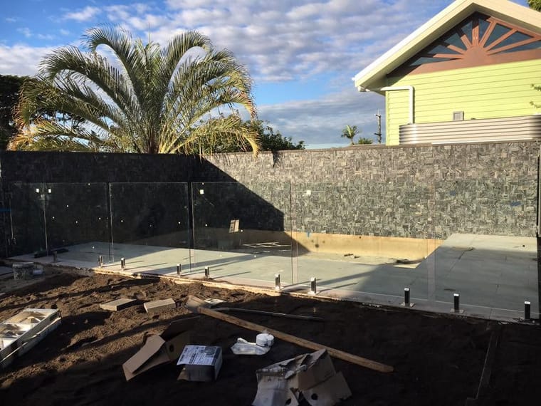 Poolside paving and stone wall mid-build — outdoor & pool surrounds in Brisbane by Torrisi Tiling