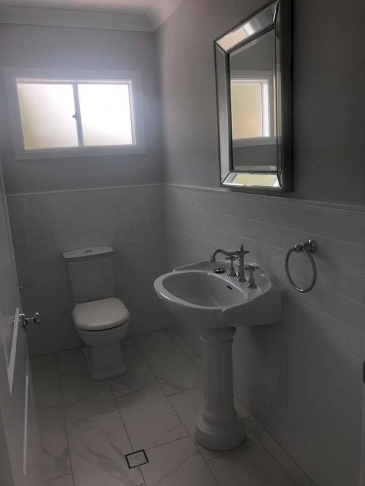 Ensuite with framed mirror and pedestal basin — tiling by Torrisi Tiling, Brisbane