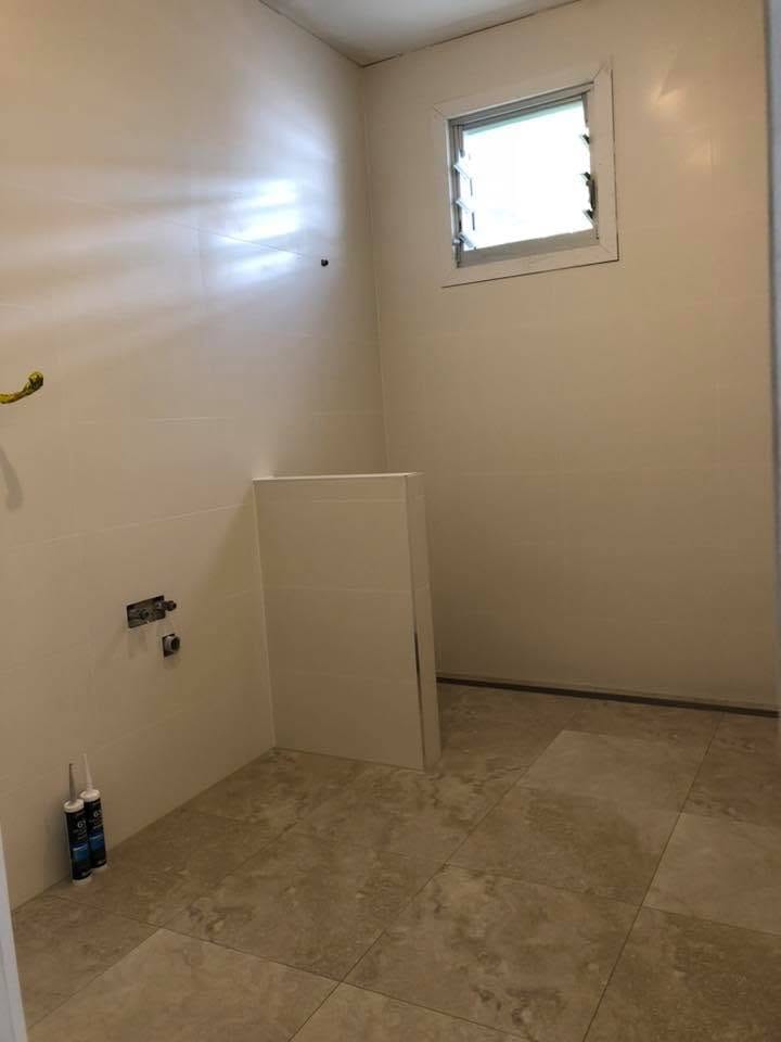 Travertine floor laid through a light-filled room — tiling by Torrisi Tiling, Brisbane
