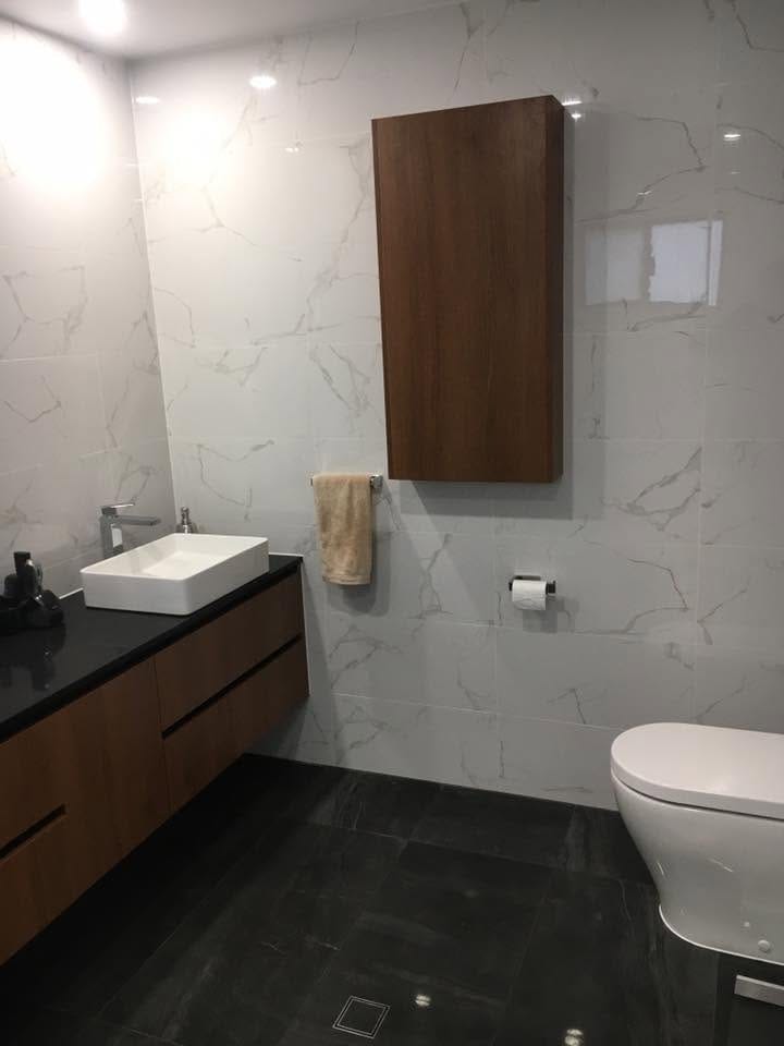 Timber vanity against a marble-look feature wall — tiling by Torrisi Tiling, Brisbane