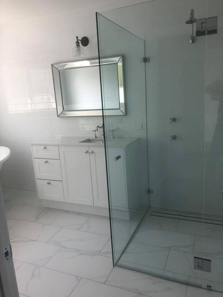 White ensuite with frameless shower — tiling by Torrisi Tiling, Brisbane
