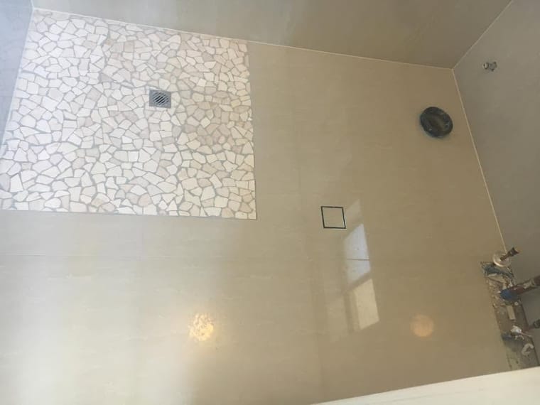 Pebble shower base with large-format walls — tiling by Torrisi Tiling, Brisbane