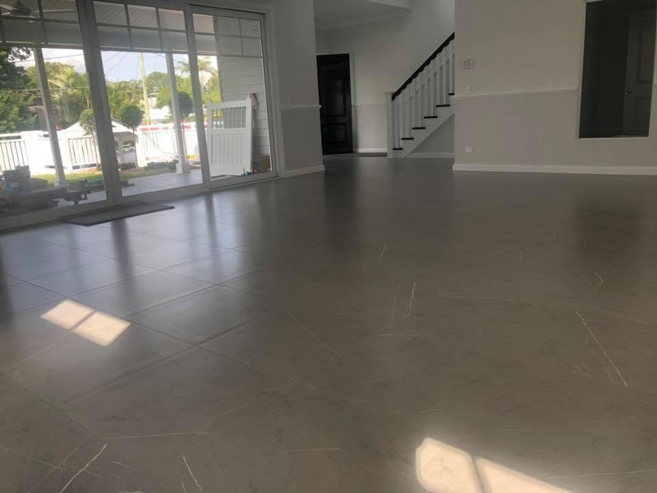 Large-format grey floor to the stair edge — tiling by Torrisi Tiling near The Gap, Brisbane