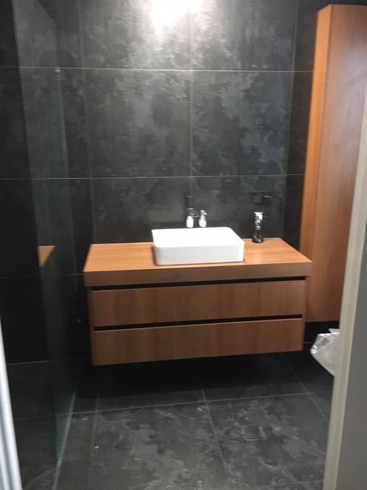 Timber vanity against dark large-format tile — tiling by Torrisi Tiling, Brisbane