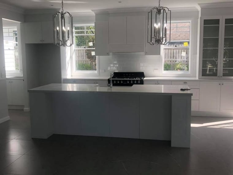 Grey island kitchen with pendant lighting — tiling by Torrisi Tiling, Brisbane