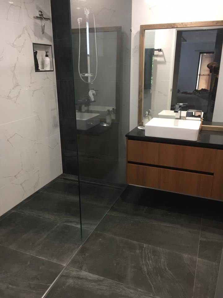 Vanity and frameless shower in dark stone-look tile — tiling by Torrisi Tiling, Brisbane