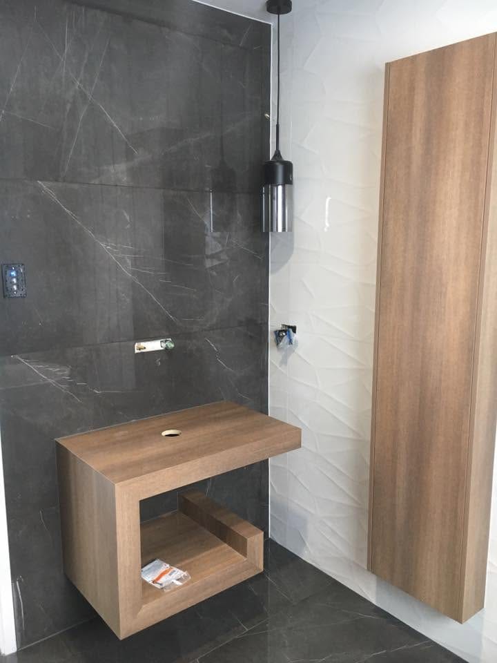 Dark shower with timber bench — tiling by Torrisi Tiling, Brisbane