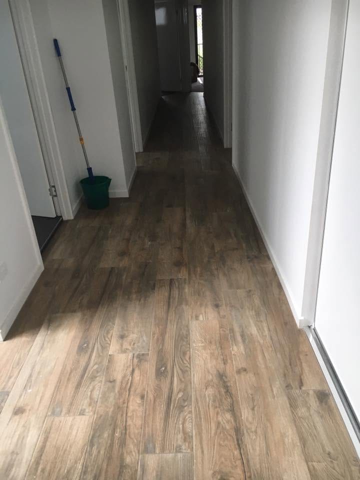 Timber-look plank running the length of the hall — tiling by Torrisi Tiling, Brisbane