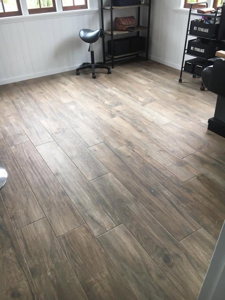 Timber-look plank tile through a living room — tiling by Torrisi Tiling, Brisbane