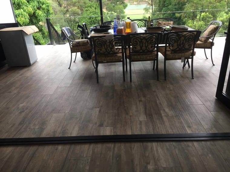 Outdoor dining on timber-look tile — tiling by Torrisi Tiling, Brisbane