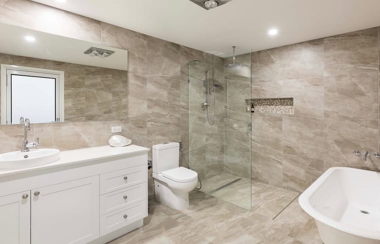 Stone-look ensuite with walk-in shower — tiling by Torrisi Tiling, Brisbane