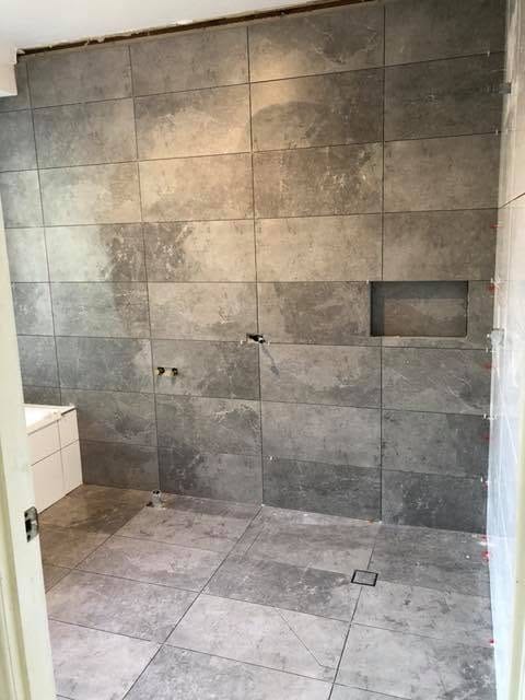Stone-look wall tile with recessed niche — tiling by Torrisi Tiling, Brisbane