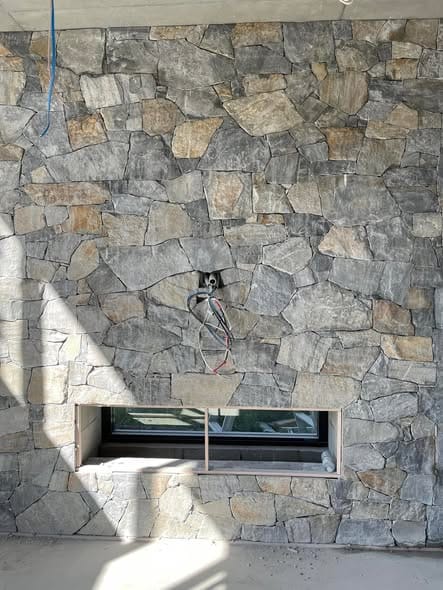 Dry-stack stone wall detail — tiling by Torrisi Tiling, Brisbane